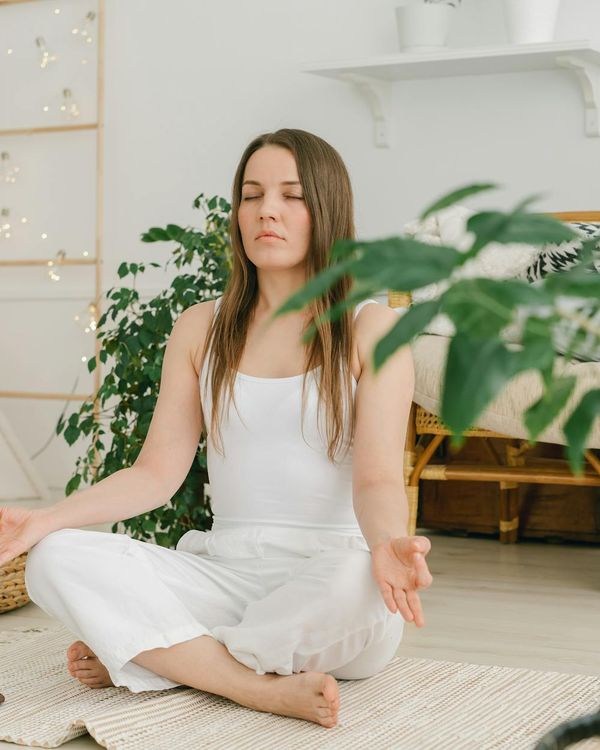 Woman in a peaceful yoga pose, representing vitality and calm.